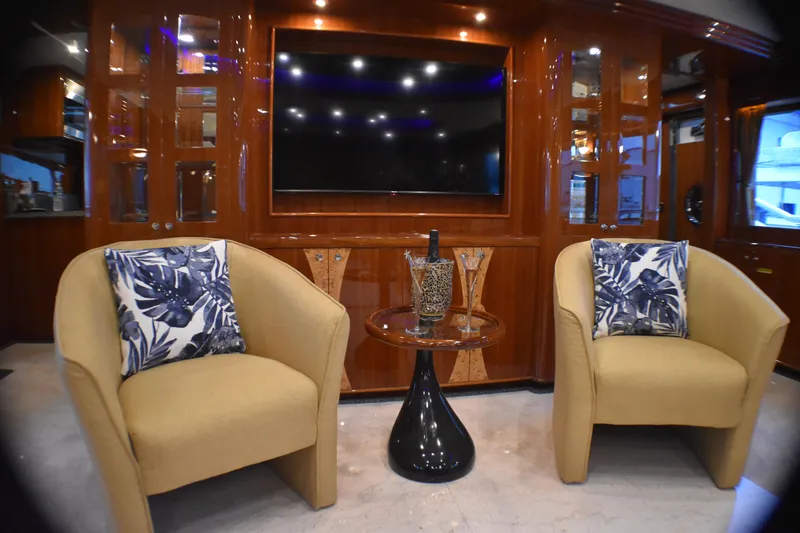 Slide: The Image of Luxurious yacht interior with plush chairs, decorative pillows, and a sleek entertainment center, 2006 Johnson model. - 27