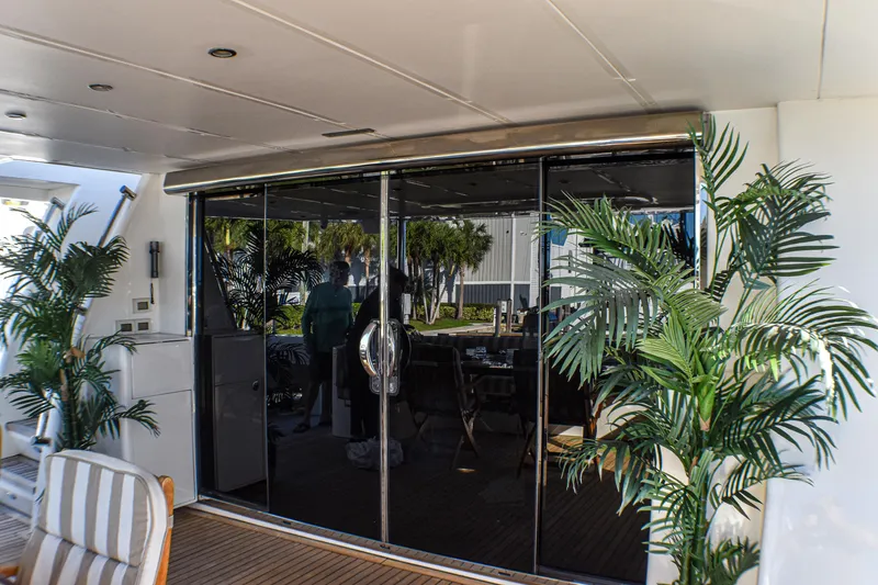 Slide: The Image of Luxurious yacht interior with glass doors, tropical plants, and striped seating, Johnson Country Kitchen 2006 model. - 9