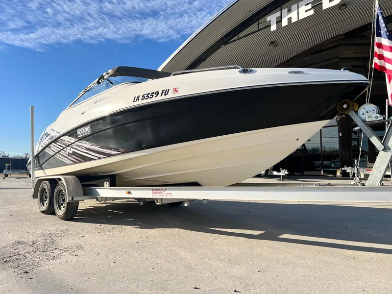 Slide: The Image of 2008 Yamaha SX230 High Output boat on trailer, parked outdoors near a building. - 10