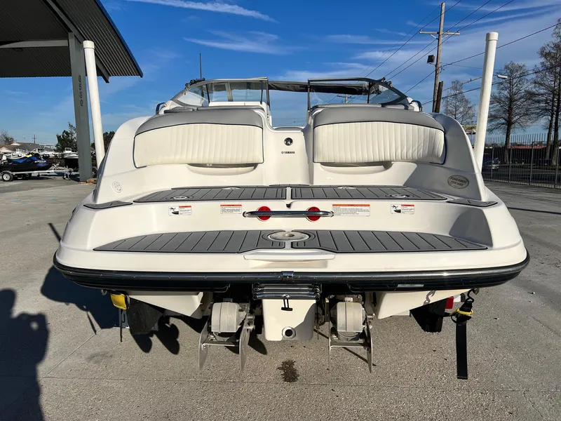 Slide: The Image of 2008 Yamaha Boats SX230 High Output, rear view, parked outdoors under clear blue sky. - 2