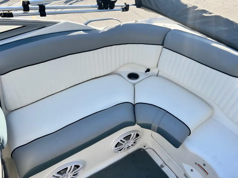 Slide: The Image of 2008 Yamaha SX230 High Output boat interior with white and gray seating and speakers. - 4