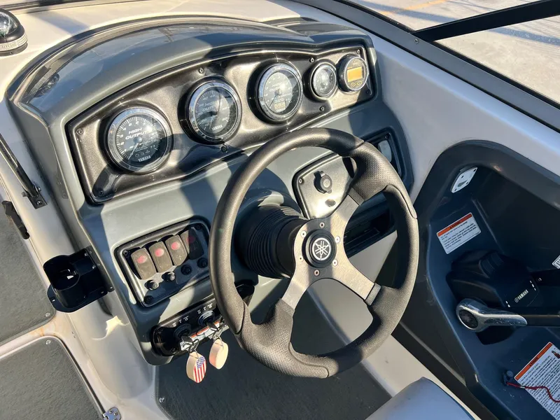 Slide: The Image of 2008 Yamaha SX230 High Output boat dashboard with steering wheel and gauges. - 6