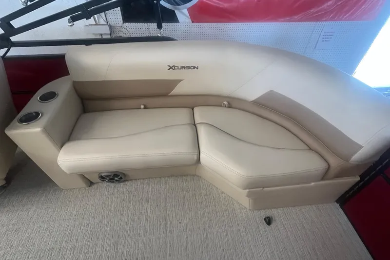 Slide: The Image of 2022 Xcursion 223 RFX boat seating with beige upholstery and cup holders. - 11