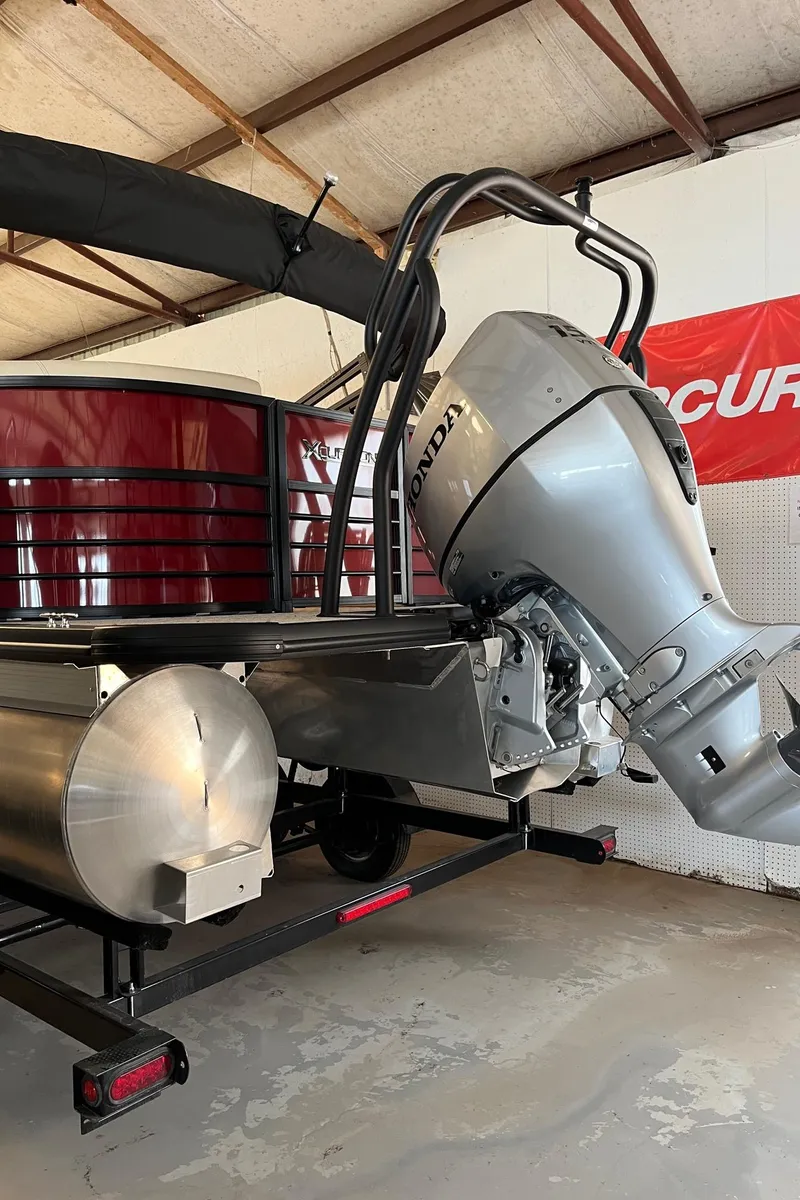 Slide: The Image of 2022 Xcursion 223 RFX pontoon boat with Honda outboard motor in showroom. - 13