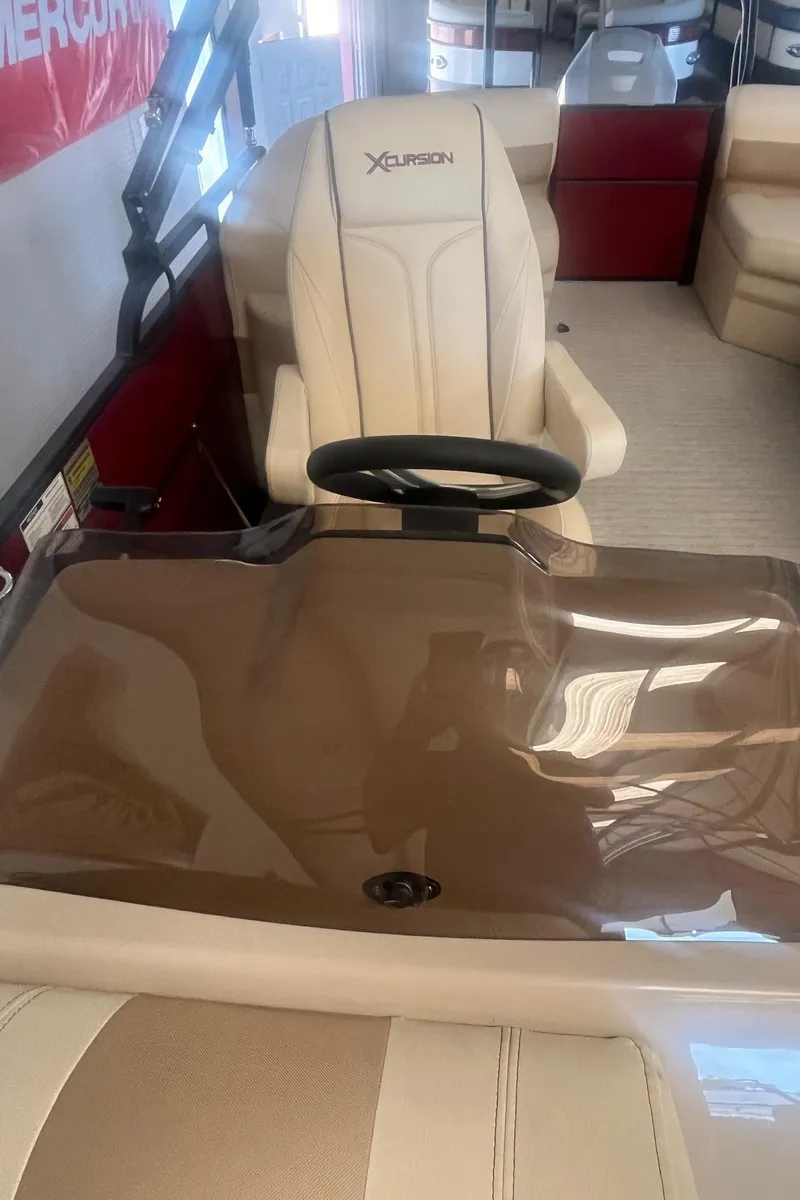 Slide: The Image of 2022 Xcursion 223 RFX boat interior with steering wheel and seating. - 8