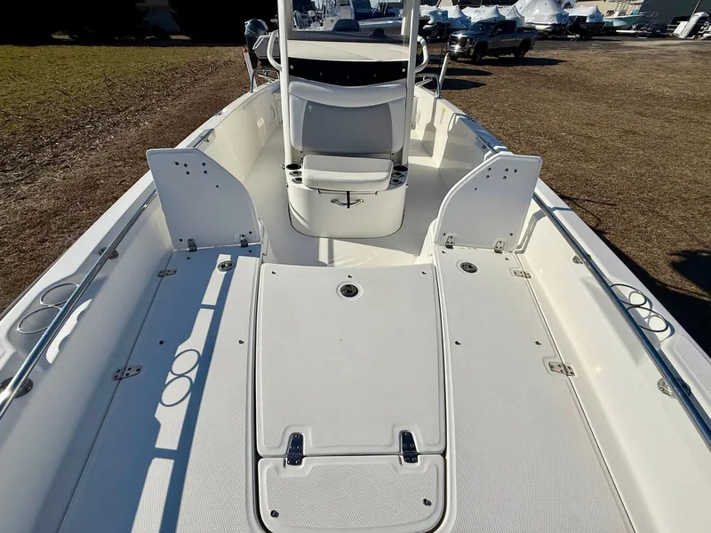 Slide: The Image of 2016 Boston Whaler 240 Dauntless boat interior, featuring spacious deck and seating area. - 10