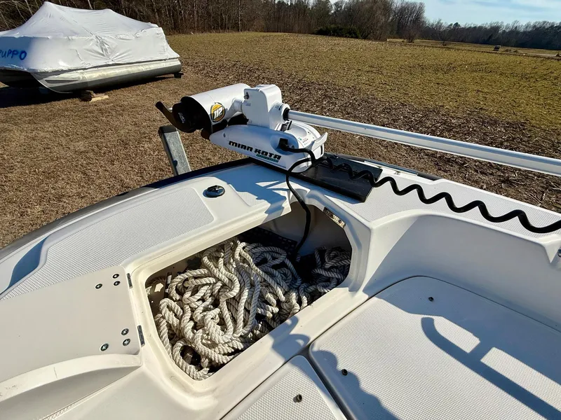 Slide: The Image of 2016 Boston Whaler 240 Dauntless boat with rope storage and trolling motor on deck. - 12
