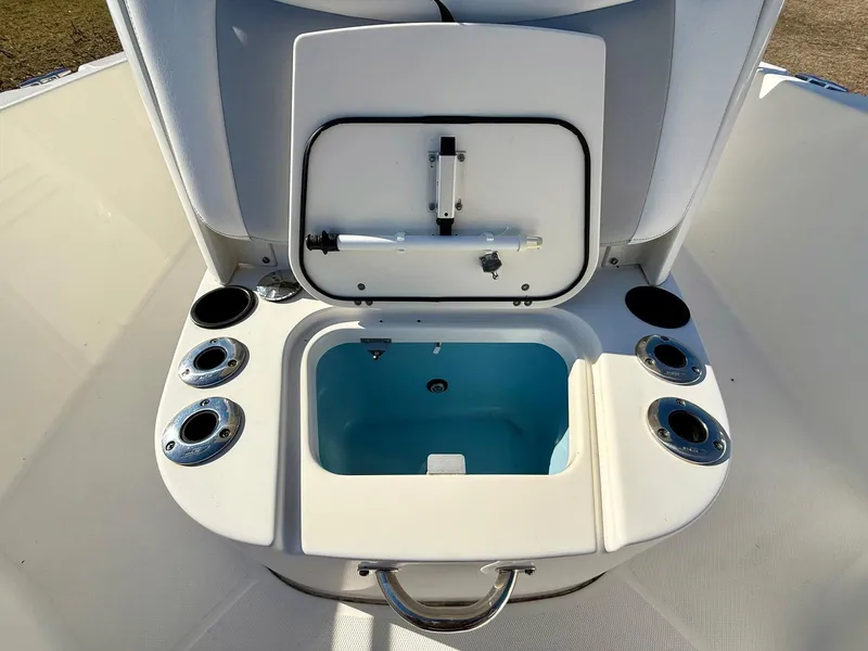Slide: The Image of 2016 Boston Whaler 240 Dauntless boat storage compartment with cup holders and handle. - 14