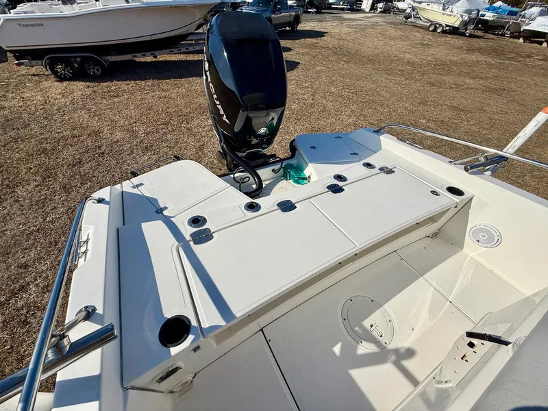 Slide: The Image of 2016 Boston Whaler 240 Dauntless boat with outboard motor, docked on dry land. - 20