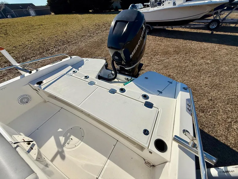 Slide: The Image of 2016 Boston Whaler 240 Dauntless boat with Mercury outboard engine, parked on grass. - 21