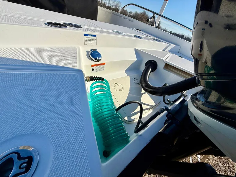 Slide: The Image of 2016 Boston Whaler 240 Dauntless boat deck with hose and engine details. - 24