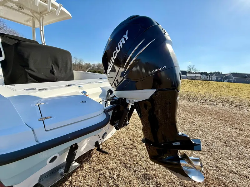Slide: The Image of 2016 Boston Whaler 240 Dauntless with Mercury outboard engine, parked on grass. - 27