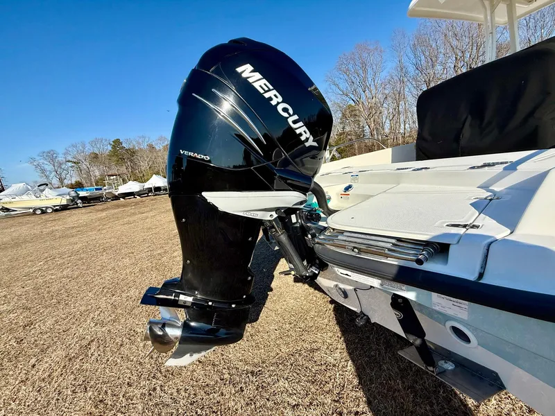 Slide: The Image of 2016 Boston Whaler 240 Dauntless with Mercury Verado outboard engine, parked on grass. - 28