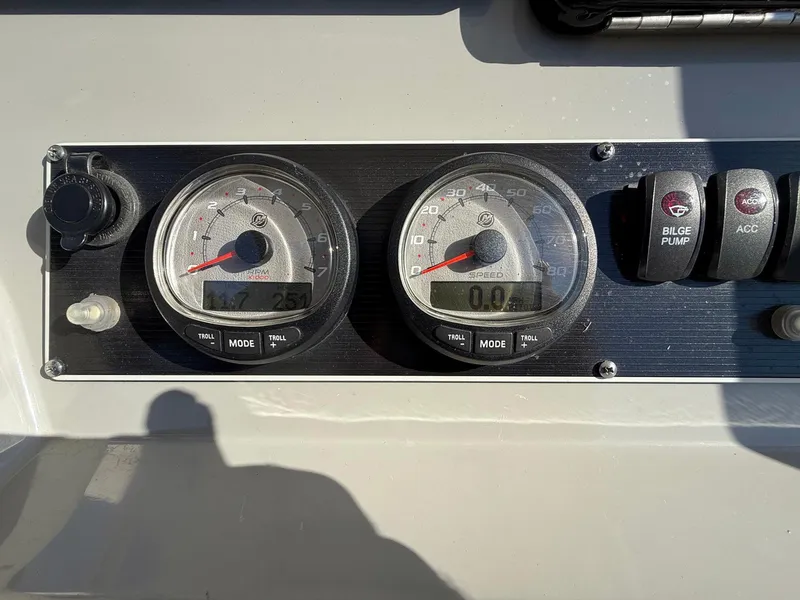 Slide: The Image of Dashboard of a 2016 Boston Whaler 240 Dauntless boat with gauges and switches. - 31