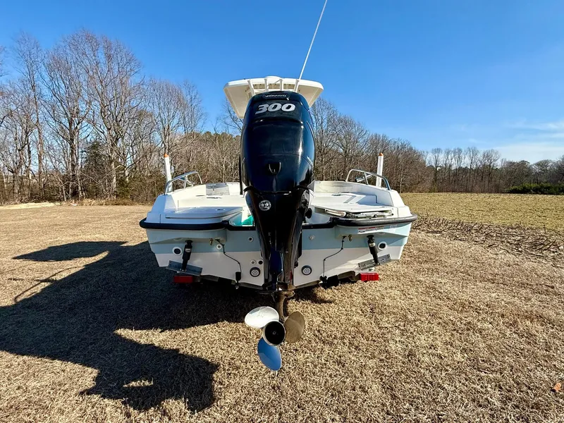 Slide: The Image of 2016 Boston Whaler 240 Dauntless boat with 300 HP engine, parked on grass. - 4