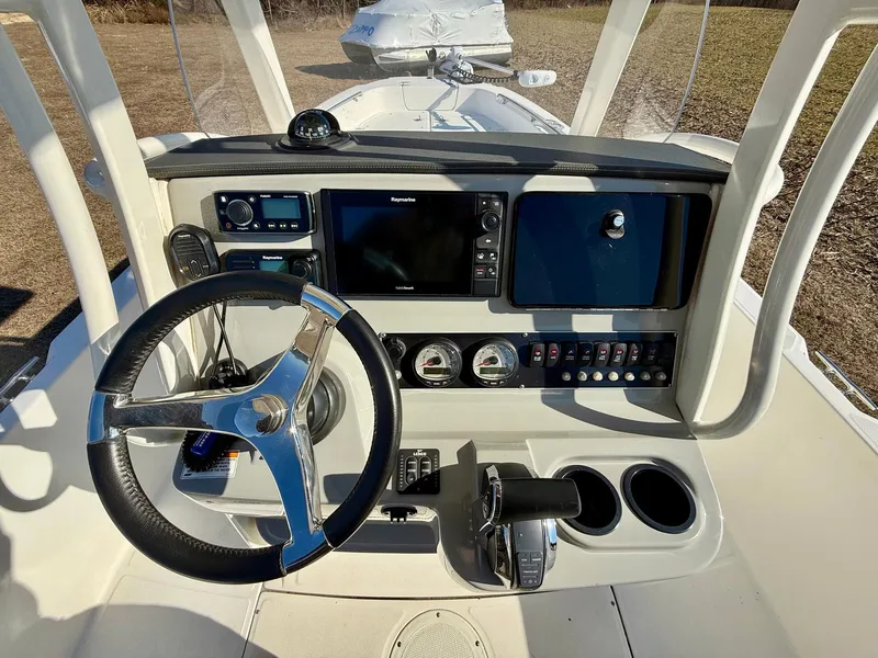 Slide: The Image of 2016 Boston Whaler 240 Dauntless helm with steering wheel, controls, and navigation system. - 6