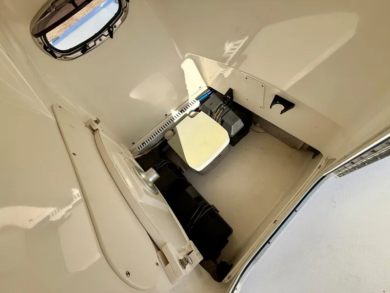 Slide: The Image of Interior of a 2016 Boston Whaler 240 Dauntless boat, featuring a compact cabin space. - 7