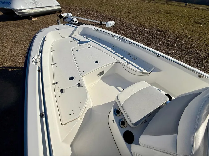 Slide: The Image of 2016 Boston Whaler 240 Dauntless boat interior with white seating and storage compartments. - 8