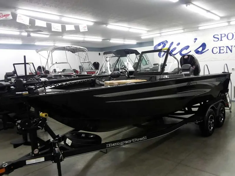 The Image of 2025 Ranger VX1888 WT boat displayed in a showroom with other boats. - 1