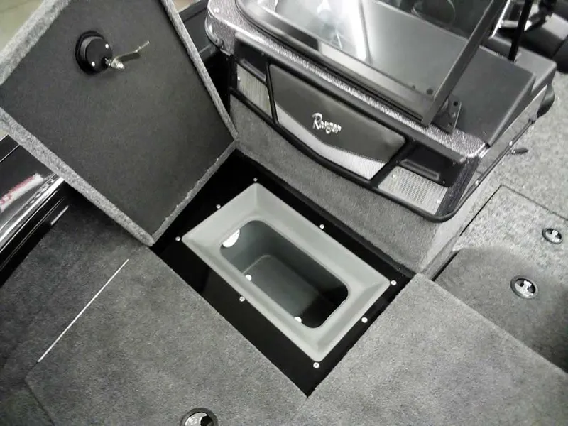 Slide: The Image of 2025 Ranger VX1888 WT boat interior with storage compartment and carpeted flooring. - 18