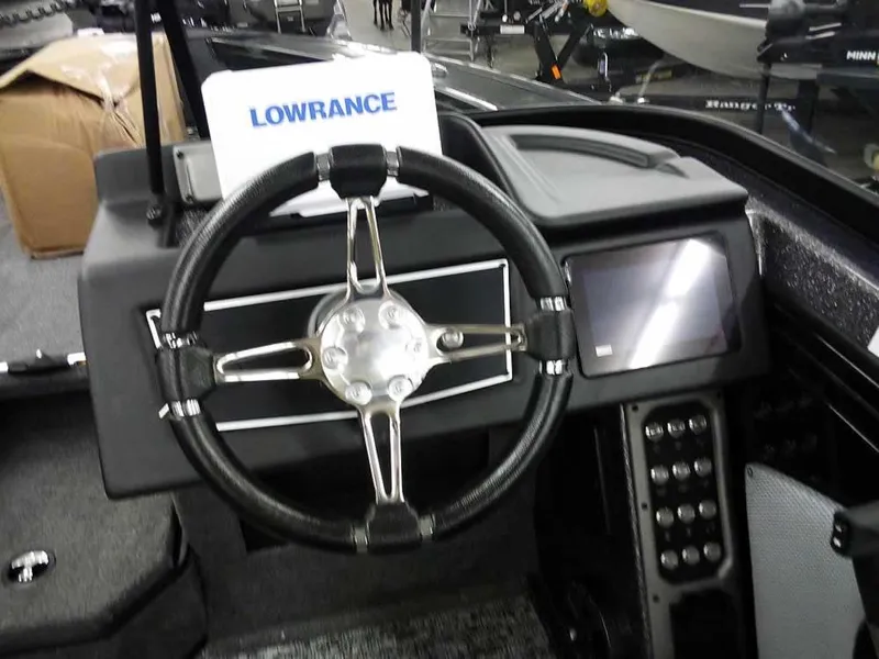 Slide: The Image of 2025 Ranger VX1888 WT boat dashboard with steering wheel and Lowrance display. - 27
