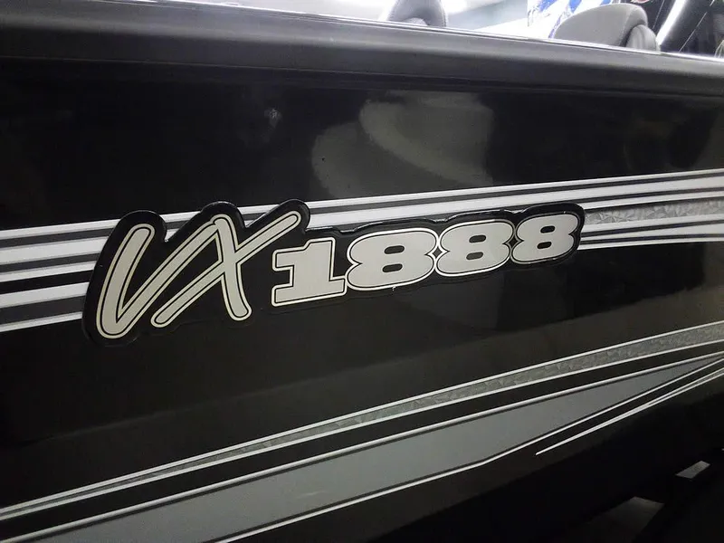 Slide: The Image of 2025 Ranger VX1888 WT boat model with sleek black and white design. - 3