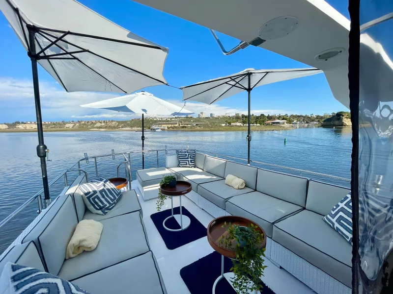 Slide: The Image of Luxurious 2003 Ocean Alexander 510 Classico yacht deck with elegant seating and umbrellas. - 14