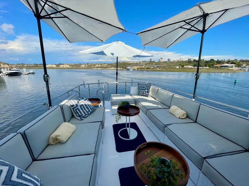 Slide: The Image of Luxurious 2003 Ocean Alexander 510 Classico yacht deck with elegant seating and umbrellas. - 15