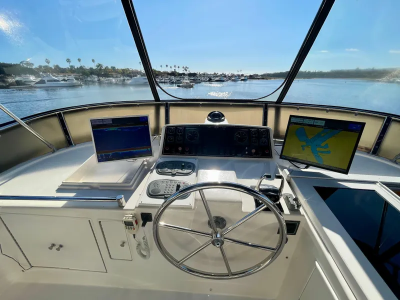 Slide: The Image of Helm of 2003 Ocean Alexander 510 Classico yacht with navigation screens and steering wheel. - 19