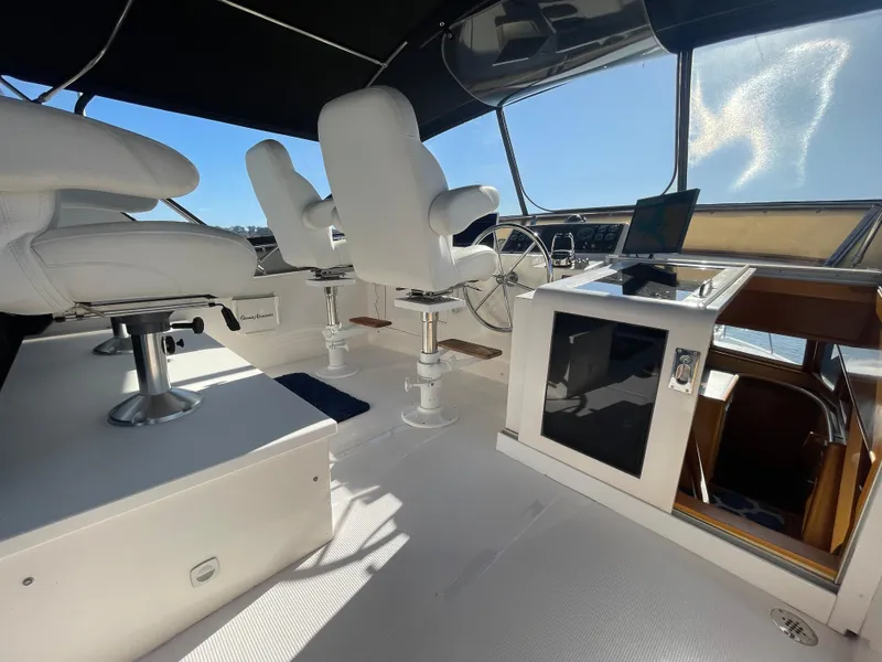 Slide: The Image of Interior of 2003 Ocean Alexander 510 Classico yacht with white seating and navigation area. - 27