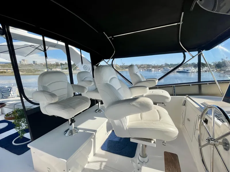 Slide: The Image of Interior of 2003 Ocean Alexander 510 Classico yacht with white captain chairs and steering wheel. - 28