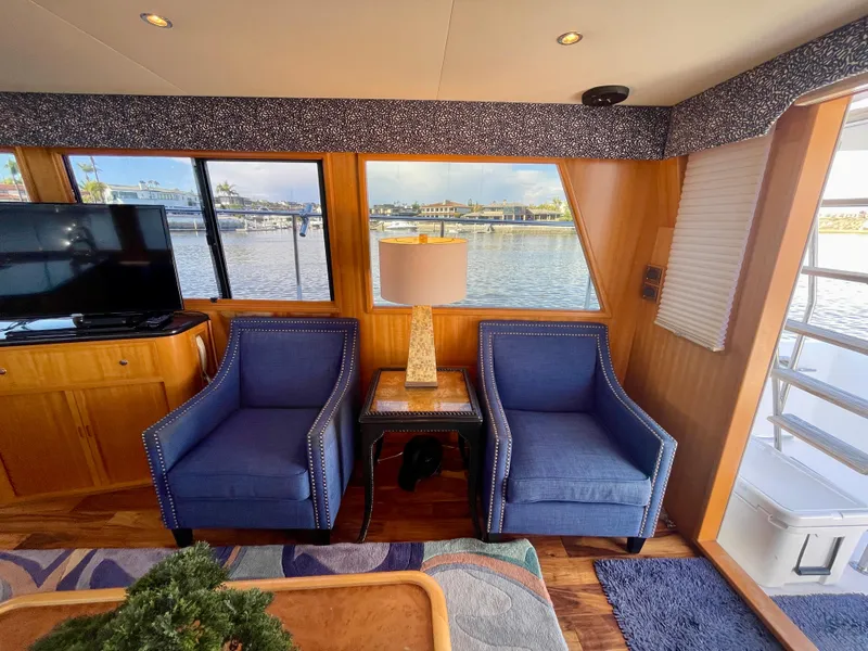 Slide: The Image of Interior of 2003 Ocean Alexander 510 Classico yacht with blue chairs and waterfront view. - 36