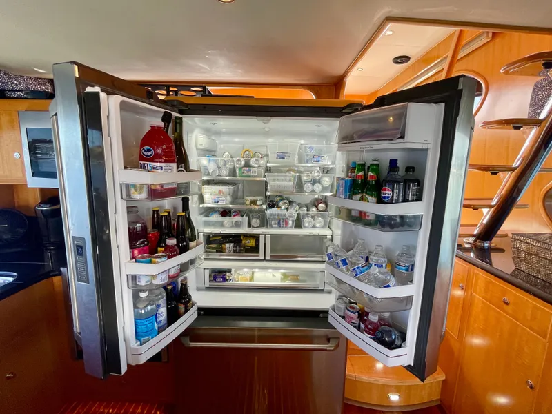 Slide: The Image of Open refrigerator filled with beverages and food inside a 2003 Ocean Alexander 510 Classico yacht. - 45