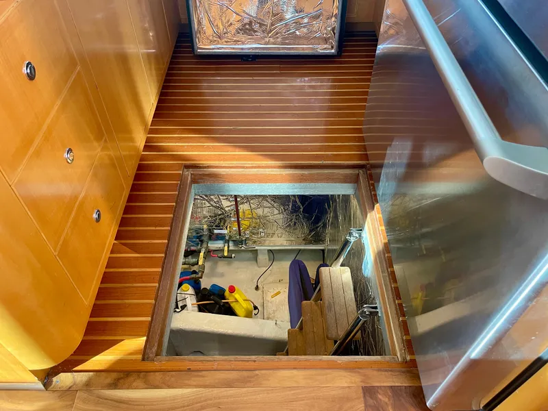 Slide: The Image of Engine room access hatch on 2003 Ocean Alexander 510 Classico yacht, featuring wooden flooring. - 46