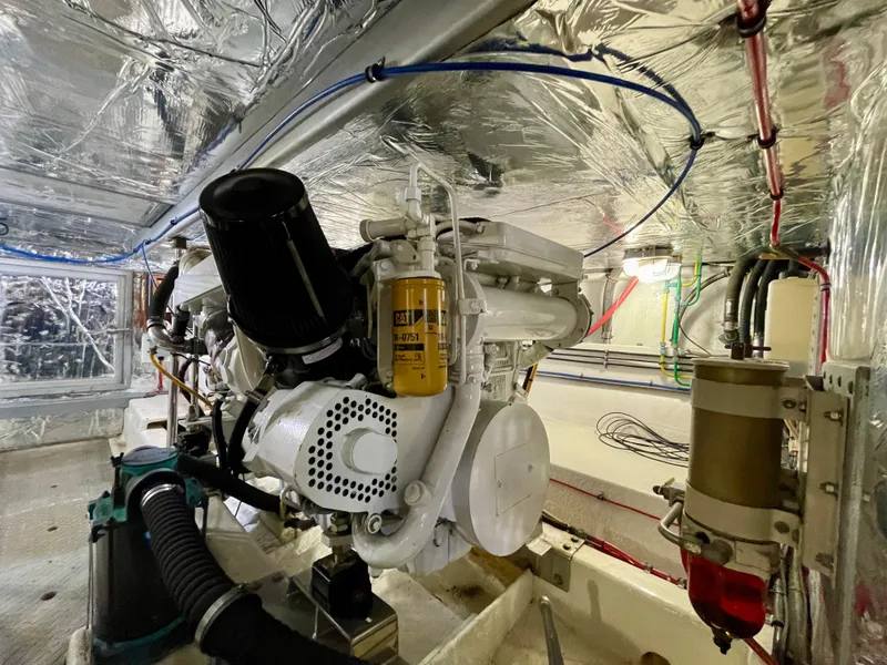 Slide: The Image of Engine room of 2003 Ocean Alexander 510 Classico yacht, showcasing mechanical components and wiring. - 48