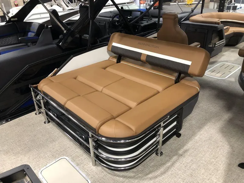 Slide: The Image of 2025 Bennington M Swingback 22 MSB boat interior with tan seating and sleek design. - 10