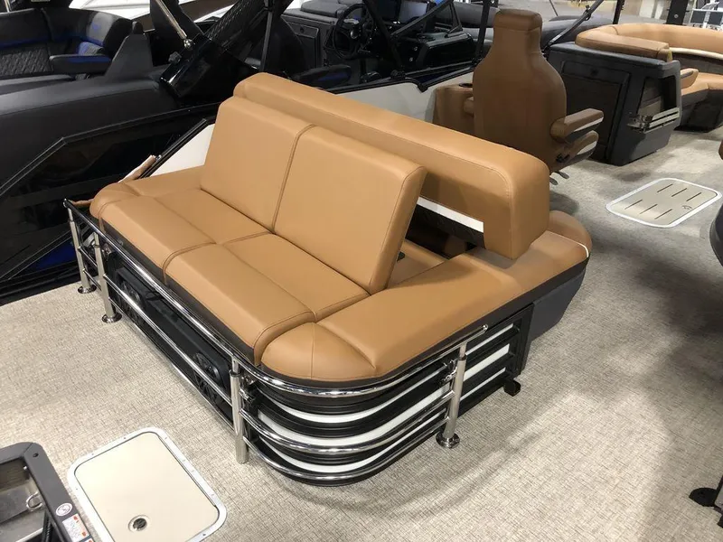 Slide: The Image of 2025 Bennington M Swingback 22 MSB boat interior with tan seating and sleek design. - 11