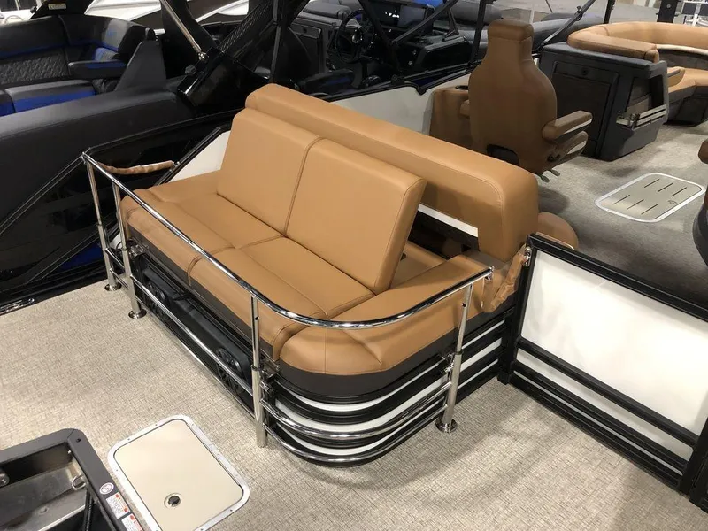 Slide: The Image of 2025 Bennington M Swingback 22 MSB boat interior with tan seating and chrome railings. - 12