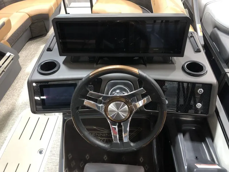 Slide: The Image of 2025 Bennington M Swingback 22 MSB dashboard with modern steering wheel and dual screens. - 7