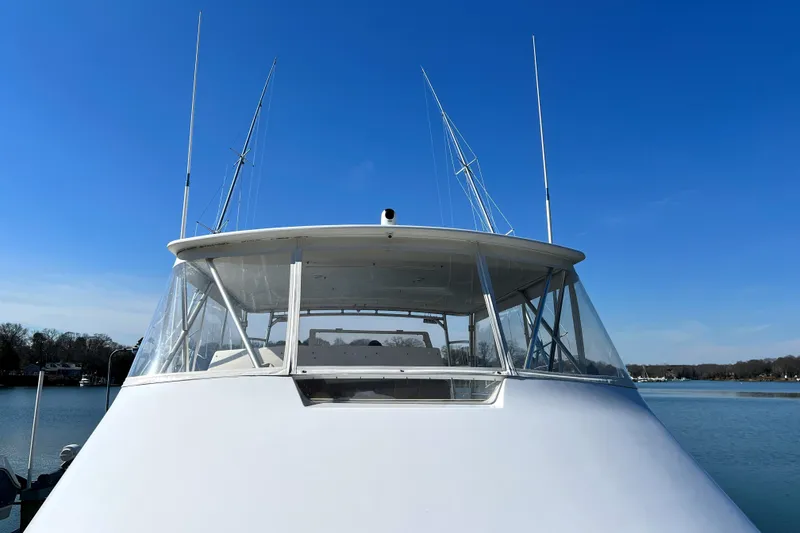 Slide: The Image of 1999 Viking 55 yacht with clear skies and calm waters. - 12