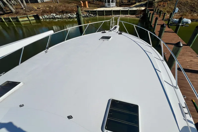 Slide: The Image of Bow view of 1999 Viking 55 yacht docked in a marina. - 14