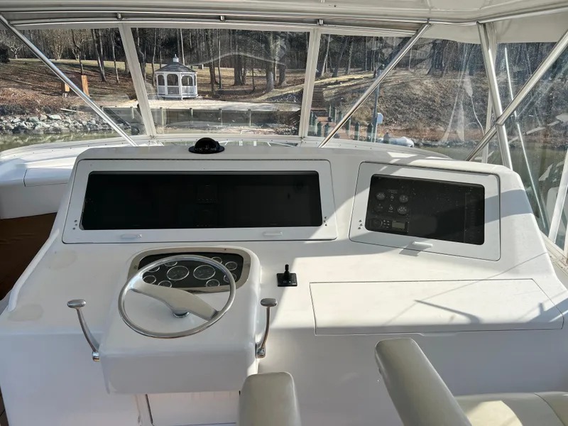 Slide: The Image of 1999 Viking 55 yacht helm with steering wheel and navigation controls. - 18