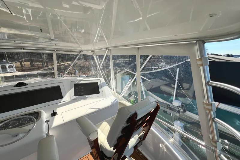 Slide: The Image of Interior view of 1999 Viking 55 yacht cockpit with steering wheel and navigation equipment. - 22