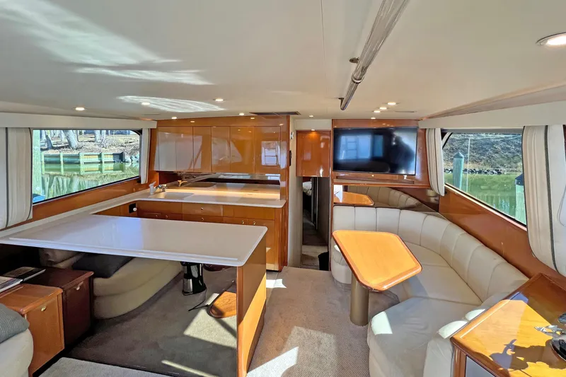 Slide: The Image of Interior of 1999 Viking 55 yacht with modern furnishings and large windows. - 26