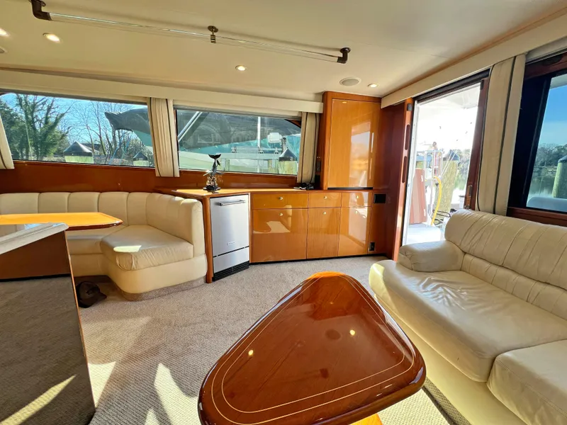 Slide: The Image of Luxurious interior of a 1999 Viking 55 yacht with plush seating and elegant wood finishes. - 27