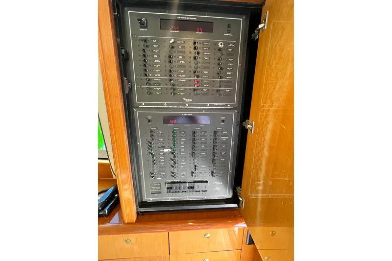 Slide: The Image of Electrical panel inside a 1999 Viking 55 yacht, showcasing control switches and indicators. - 29