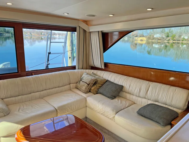 Slide: The Image of Luxurious interior of a 1999 Viking 55 yacht with plush seating and scenic water view. - 30