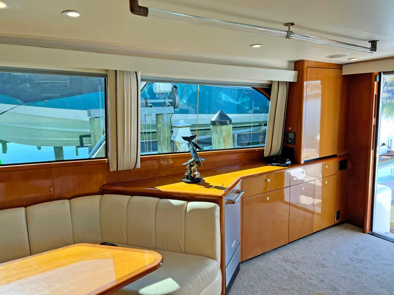 Slide: The Image of Interior of 1999 Viking 55 yacht with elegant wood finish and comfortable seating. - 31