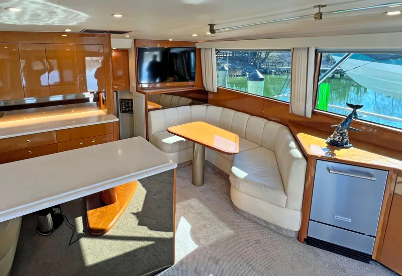 Slide: The Image of Luxurious interior of a 1999 Viking 55 yacht with modern amenities and elegant seating. - 32