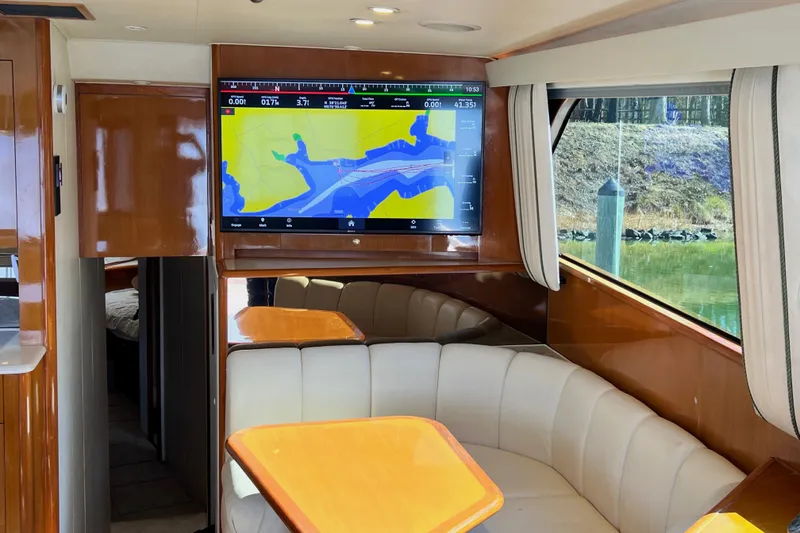 Slide: The Image of Interior of 1999 Viking 55 yacht with navigation screen and plush seating. - 33